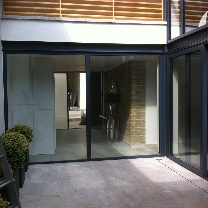 Floor-to-ceiling sliding doors opening to courtyard in Palmers Green