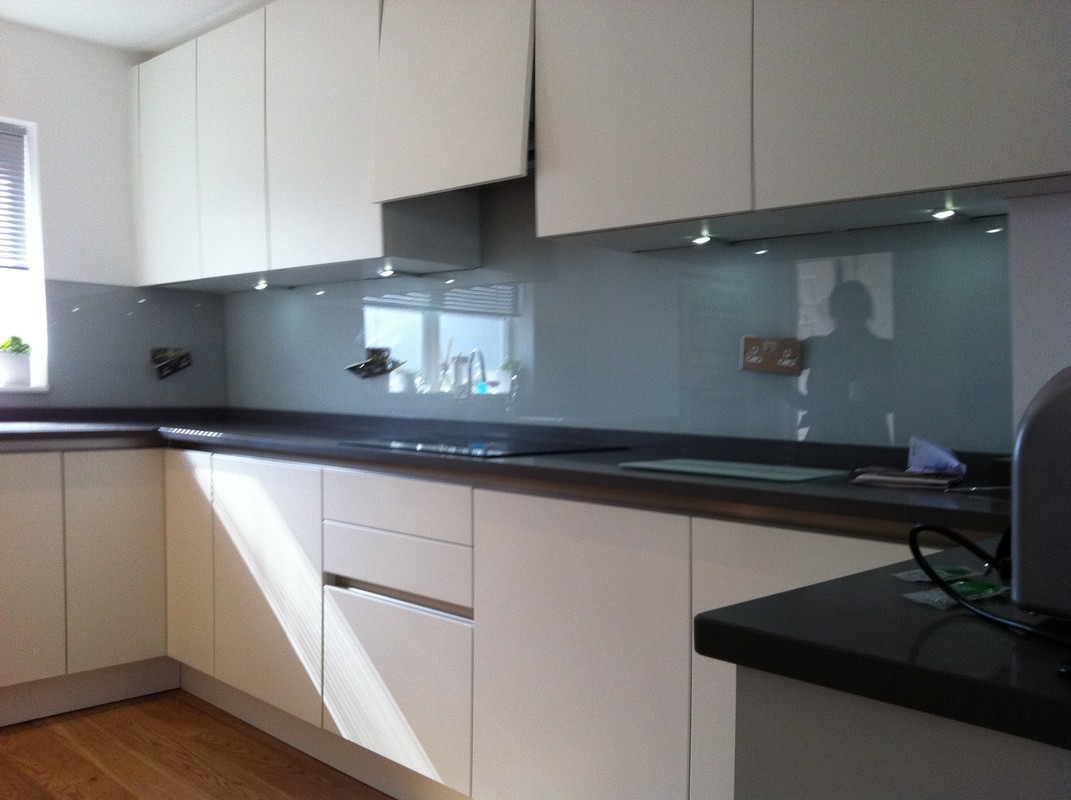 Grey glass kitchen splashback with LED lighting in Palmers Green