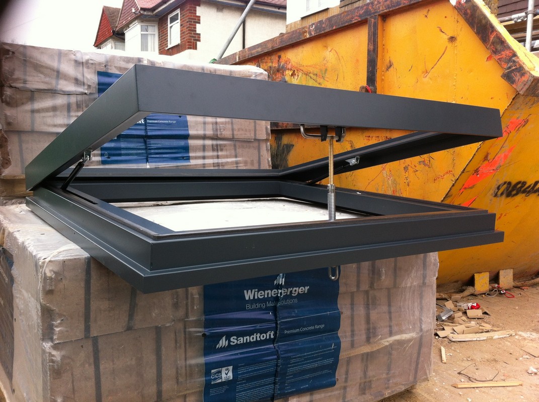 Opening flat roof skylight in anthracite grey installed in Palmers Green