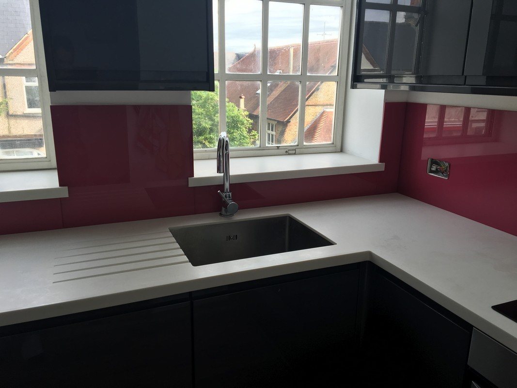 Deep plum coloured glass splashback in modern Palmers Green kitchen